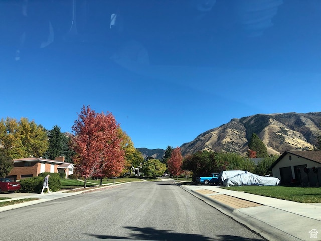 2047 N 1350 E, North Logan, UT 84341 - view of asphalt street with sidewalks, curbs, and a mountain view
