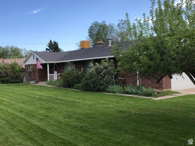 2047 N 1350 E, North Logan, UT 84341 - view of front facade with brick siding, a front lawn, a shingled roof, and a chimney