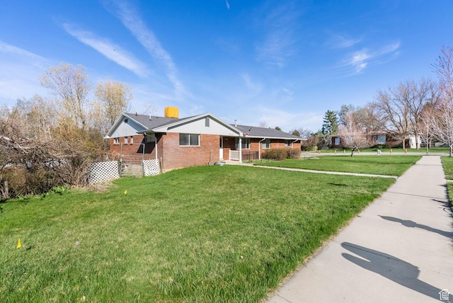 2047 N 1350 E, North Logan, UT 84341 - ranch-style home featuring brick siding, a front lawn, and covered porch