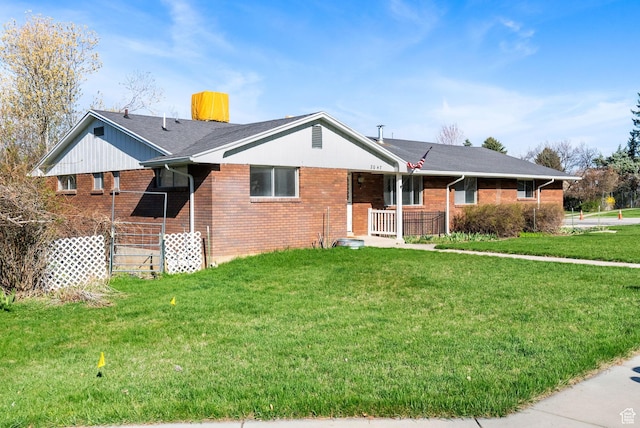 2047 N 1350 E, North Logan, UT 84341 - single story home featuring brick siding, a front lawn, and covered porch