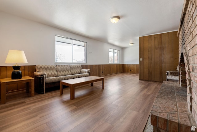 2047 N 1350 E, North Logan, UT 84341 - living room with wooden walls, a wainscoted wall, wood finished floors, and a brick fireplace