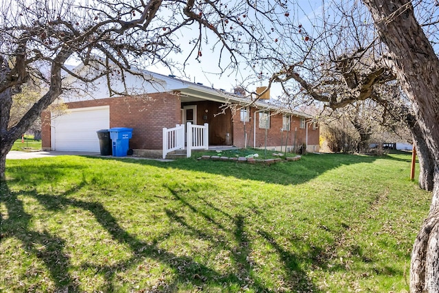 2047 N 1350 E, North Logan, UT 84341 - view of side of property featuring brick siding, a lawn, an attached garage, and concrete driveway