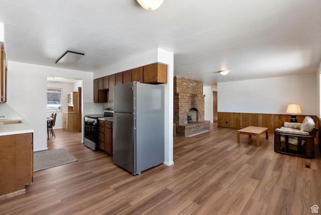 2047 N 1350 E, North Logan, UT 84341 - kitchen with appliances with stainless steel finishes, open floor plan, light wood-style flooring, a wainscoted wall, and light countertops