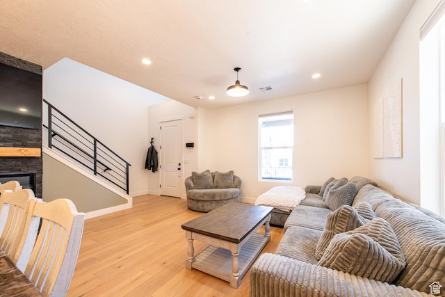 695 W Claystone Dr, St George, UT 84790 - living area with a fireplace, recessed lighting, visible vents, light wood-style flooring, and stairs
