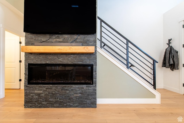 695 W Claystone Dr, St George, UT 84790 - details with baseboards, wood finished floors, and a stone fireplace