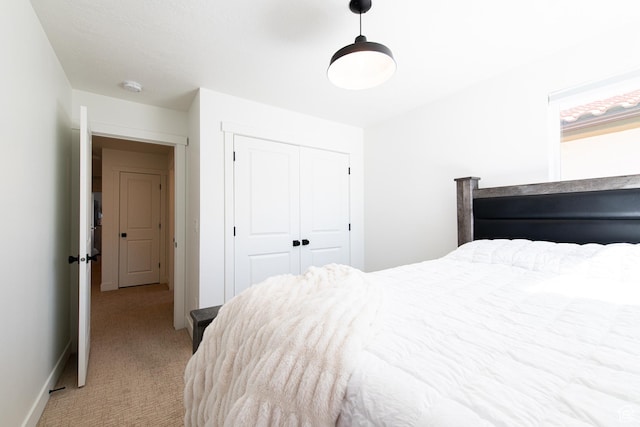 695 W Claystone Dr, St George, UT 84790 - bedroom featuring light carpet, a closet, and baseboards