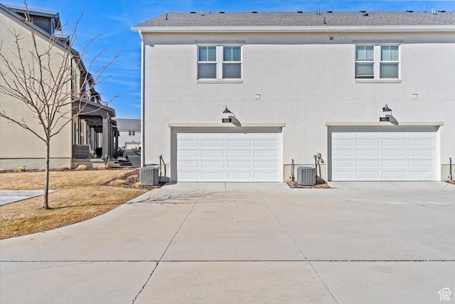 5927 W Lake Ave S, South Jordan, UT 84009 - view of front facade with central air condition unit, an attached garage, concrete driveway, and stucco siding