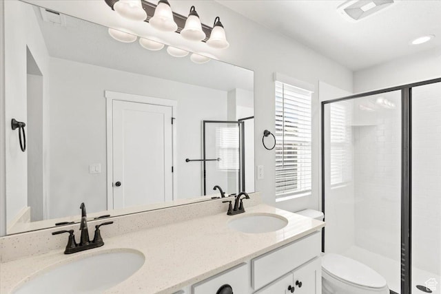 5927 W Lake Ave S, South Jordan, UT 84009 - bathroom featuring visible vents, a sink, a shower stall, and toilet