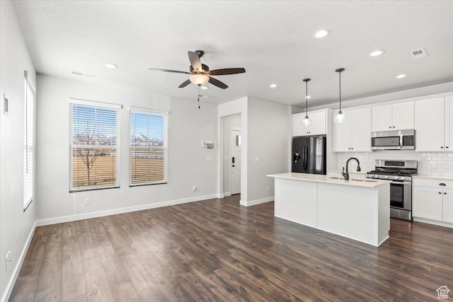 5927 W Lake Ave S, South Jordan, UT 84009 - kitchen with visible vents, decorative backsplash, dark wood finished floors, appliances with stainless steel finishes, and a sink