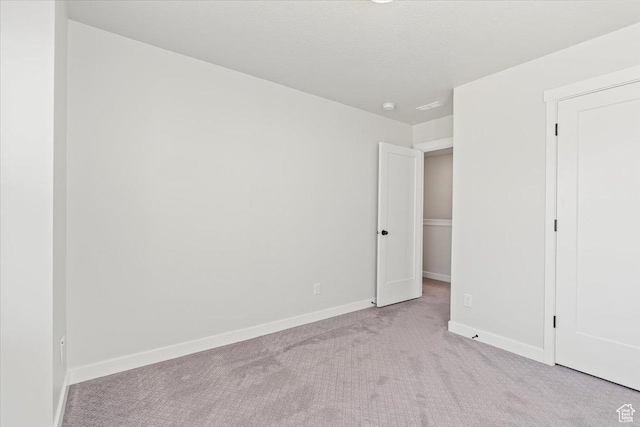 5927 W Lake Ave S, South Jordan, UT 84009 - unfurnished bedroom featuring a textured ceiling, baseboards, and carpet flooring