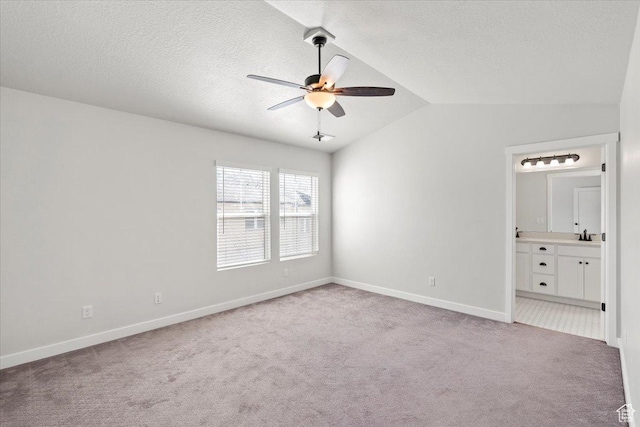 5927 W Lake Ave S, South Jordan, UT 84009 - interior space with lofted ceiling, light colored carpet, connected bathroom, a textured ceiling, and baseboards