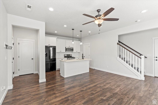 5927 W Lake Ave S, South Jordan, UT 84009 - kitchen with open floor plan, light countertops, appliances with stainless steel finishes, and dark wood finished floors