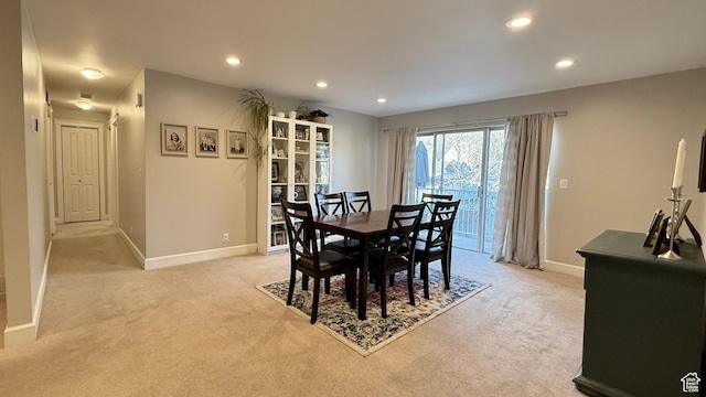 dining area featuring recessed lighting, light colored carpet, and baseboards