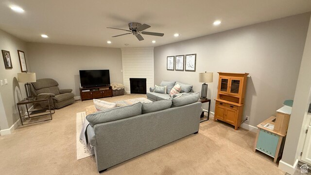 living area featuring ceiling fan, recessed lighting, light carpet, a fireplace, and baseboards