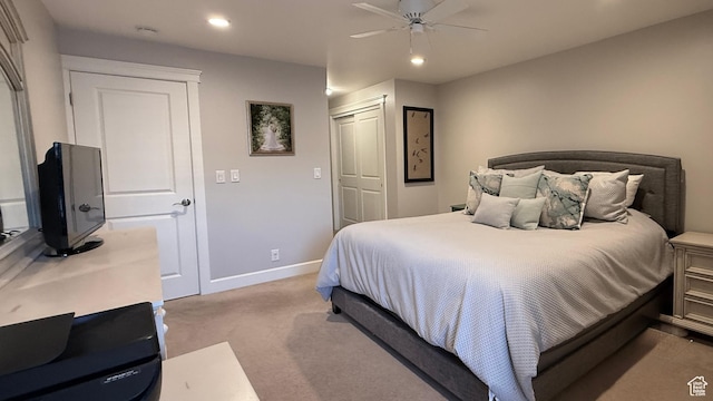 bedroom with light carpet, baseboards, a ceiling fan, a closet, and recessed lighting