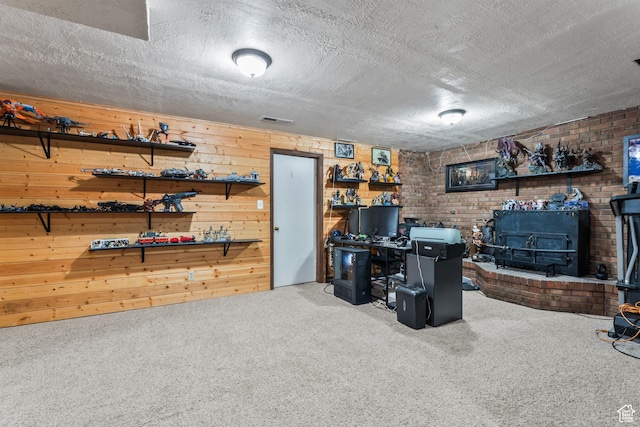 2490 W 12195 S, Riverton, UT 84065 - office with a wood stove, carpet floors, a textured ceiling, wooden walls, and brick wall