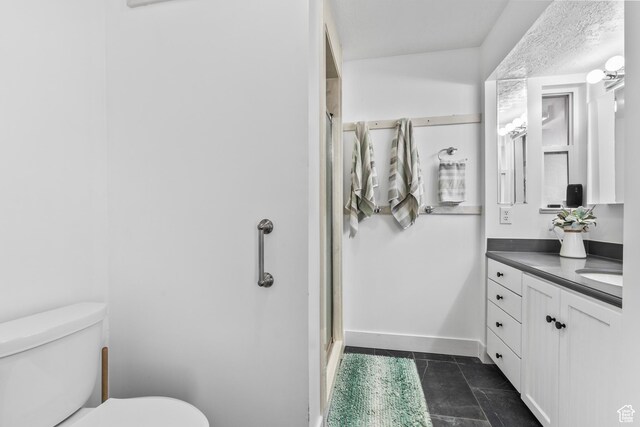 2490 W 12195 S, Riverton, UT 84065 - bathroom with toilet, a stall shower, vanity, tile patterned floors, and baseboards