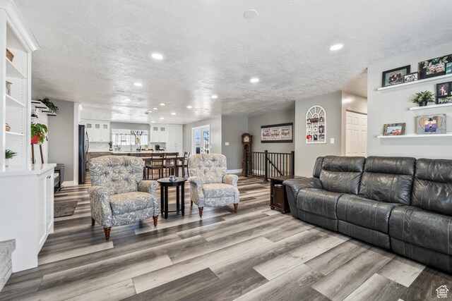 2490 W 12195 S, Riverton, UT 84065 - living area with light wood-type flooring, recessed lighting, baseboards, and a textured ceiling