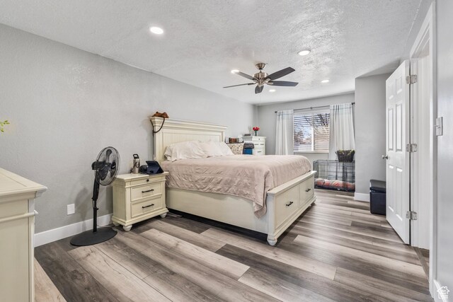 2490 W 12195 S, Riverton, UT 84065 - bedroom featuring a textured ceiling, baseboards, light wood-type flooring, recessed lighting, and a ceiling fan
