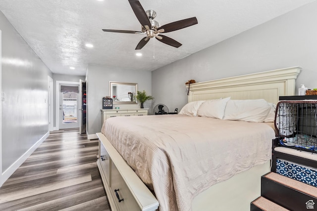 2490 W 12195 S, Riverton, UT 84065 - bedroom featuring dark wood-style flooring, recessed lighting, baseboards, a ceiling fan, and a textured ceiling