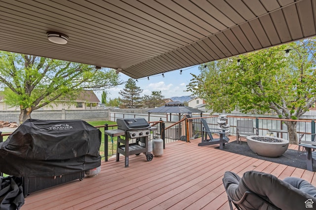 2490 W 12195 S, Riverton, UT 84065 - wooden deck featuring an outdoor fire pit, a fenced backyard, and grilling area