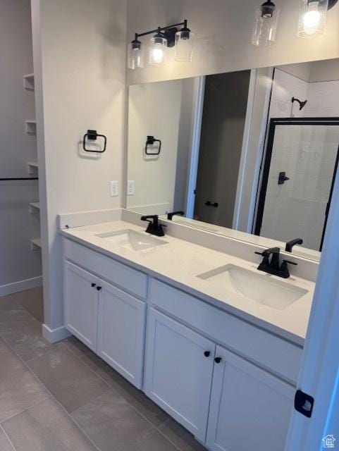 2086 S 4140 W Unit 74, Taylor, UT 84401 - bathroom with double vanity, a shower stall, baseboards, and a sink