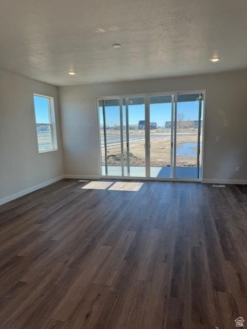 2086 S 4140 W Unit 74, Taylor, UT 84401 - empty room with a wealth of natural light, dark wood-style flooring, and baseboards