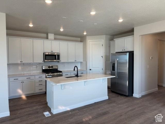 2086 S 4140 W Unit 74, Taylor, UT 84401 - kitchen with stainless steel appliances, backsplash, dark wood-type flooring, white cabinets, and a sink