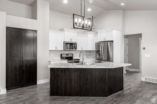 154 S Liberty St Unit 204, Grantsville, UT 84029 - kitchen featuring visible vents, high vaulted ceiling, a notable chandelier, white cabinets, and stainless steel appliances