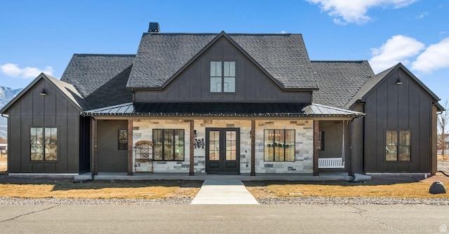 view of front of house with a standing seam roof, a porch, and board and batten siding
