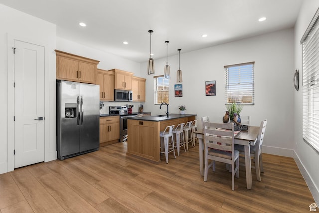 501 W 2300 S, Richfield, UT 84701 - kitchen with recessed lighting, stainless steel appliances, wood finished floors, a sink, and dark countertops