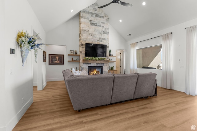 501 W 2300 S, Richfield, UT 84701 - living room with baseboards, light wood-style flooring, ceiling fan, a fireplace, and high vaulted ceiling