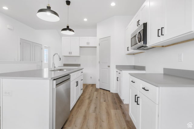 271 N 1160 N Unit 32, Tooele, UT 84074 - kitchen with recessed lighting, a sink, appliances with stainless steel finishes, light wood finished floors, and decorative light fixtures