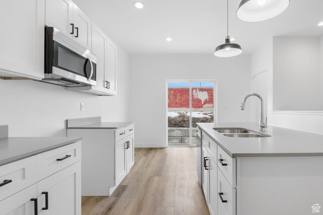 271 N 1160 N Unit 32, Tooele, UT 84074 - kitchen featuring a sink, white cabinetry, light countertops, appliances with stainless steel finishes, and light wood-type flooring
