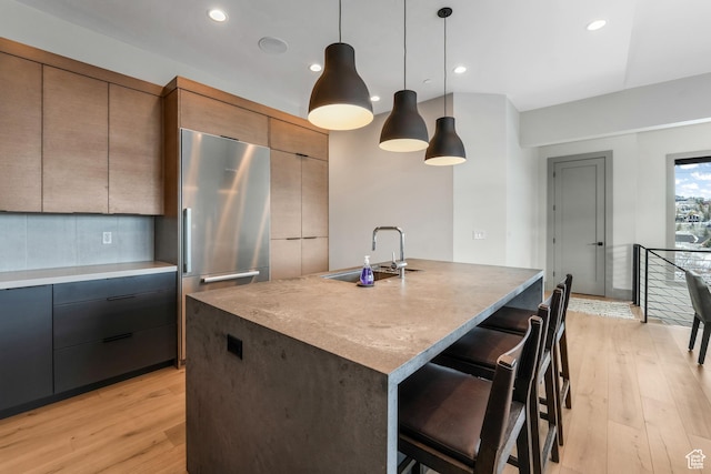 4371 Frost Haven Rd, Park City, UT 84098 - kitchen featuring a sink, light wood-type flooring, modern cabinets, stainless steel fridge, and a center island with sink
