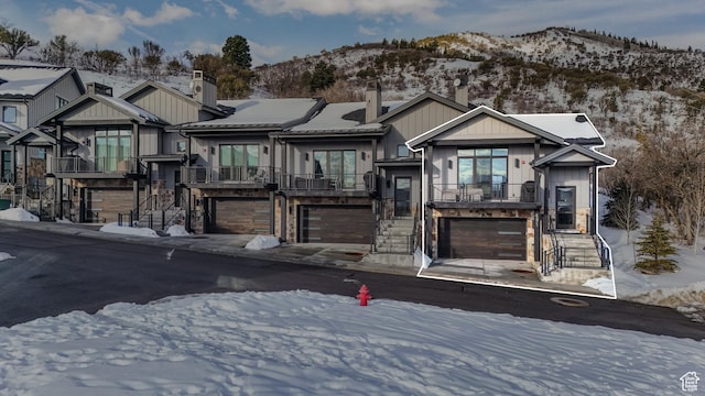 4371 Frost Haven Rd, Park City, UT 84098 - view of front of property featuring a garage, stone siding, and a mountain view