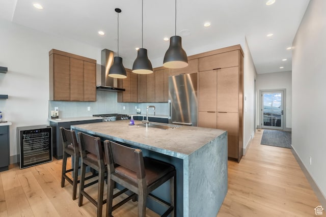 4371 Frost Haven Rd, Park City, UT 84098 - kitchen with beverage cooler, wall chimney exhaust hood, modern cabinets, stainless steel appliances, and a sink
