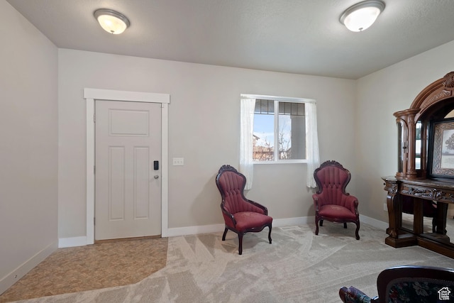 sitting room with carpet and baseboards