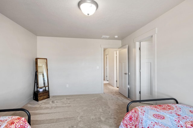 bedroom with carpet, a textured ceiling, and baseboards
