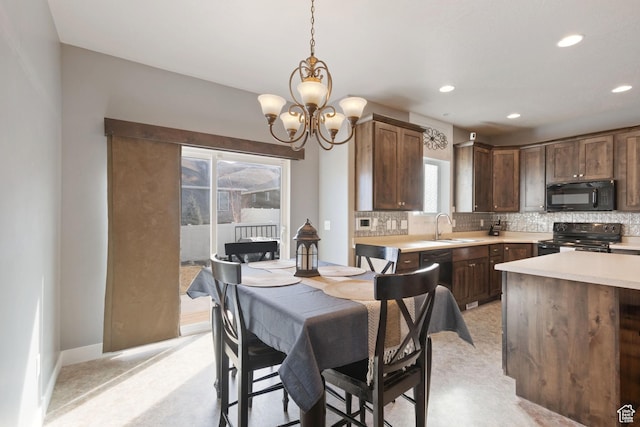 dining space with baseboards, a notable chandelier, and recessed lighting