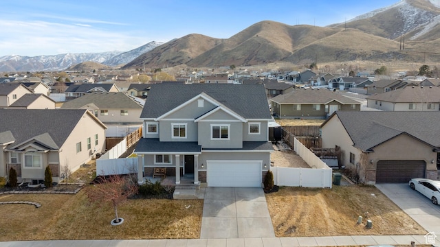 exterior space with concrete driveway, fence, a residential view, and stucco siding