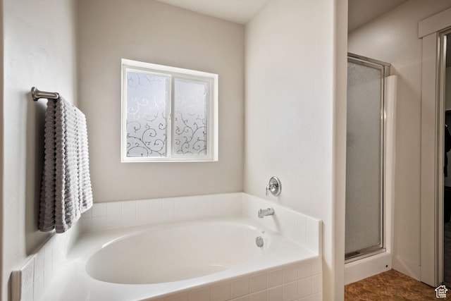 full bathroom with a garden tub and a shower stall