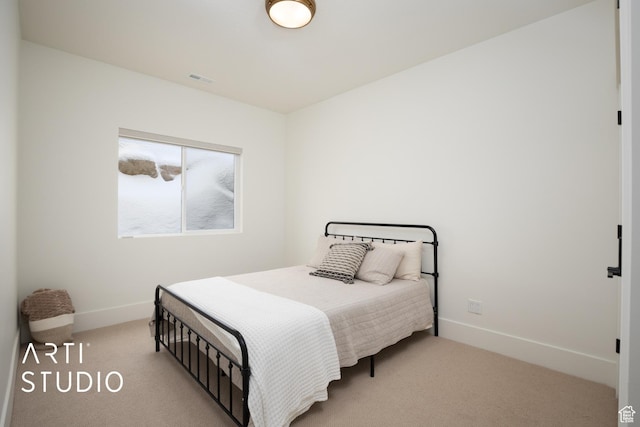 bedroom featuring carpet and baseboards