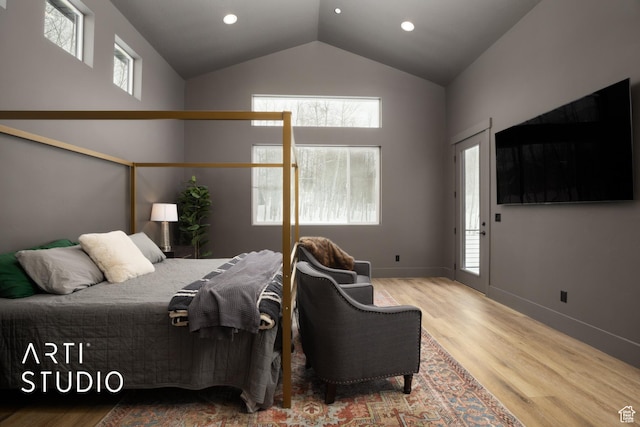 bedroom with high vaulted ceiling, multiple windows, baseboards, and wood finished floors