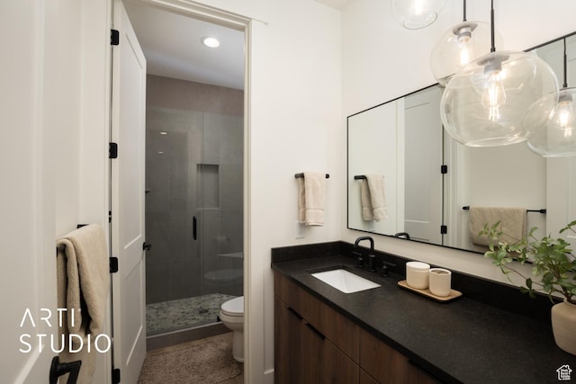 bathroom featuring toilet, a shower stall, recessed lighting, and vanity