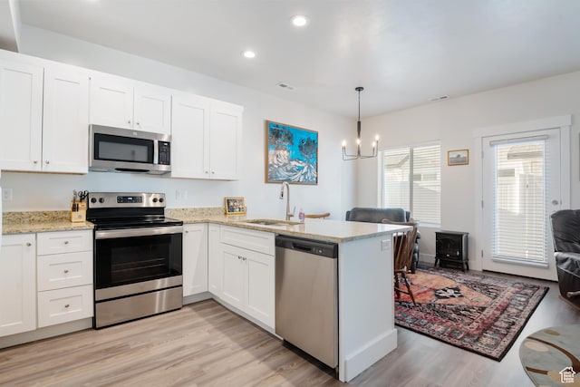 336 N 100 W, Morgan, UT 84050 - kitchen featuring stainless steel appliances, a peninsula, and white cabinetry