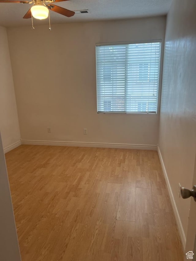 196 E Spencer Peak Way S Unit D9, Draper, UT 84020 - empty room featuring visible vents, baseboards, a ceiling fan, a textured ceiling, and light wood-style floors