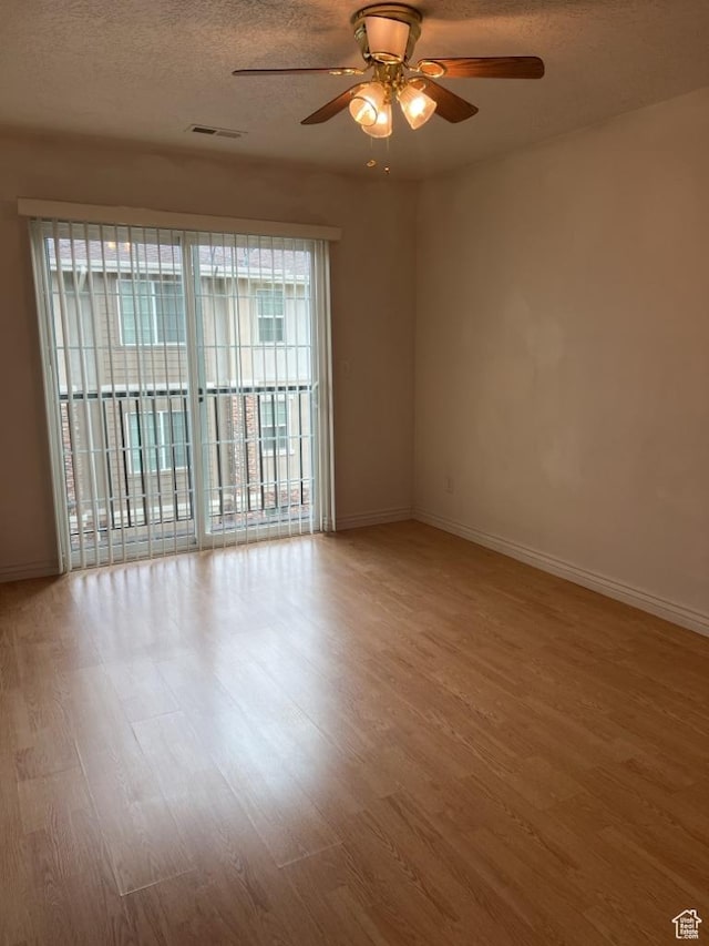 196 E Spencer Peak Way S Unit D9, Draper, UT 84020 - spare room with a textured ceiling, wood finished floors, visible vents, and baseboards