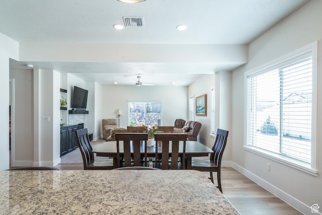 1044 E Southern Homestead Blvd, Enoch, UT 84721 - dining space featuring baseboards, visible vents, light wood-style floors, a fireplace, and recessed lighting