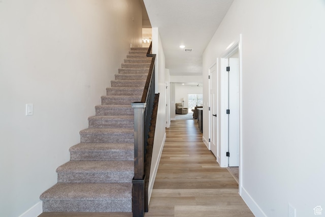 1044 E Southern Homestead Blvd, Enoch, UT 84721 - stairs featuring wood finished floors, visible vents, and baseboards